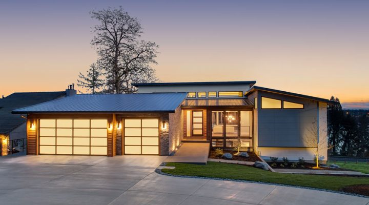 a charming home built in a lovely area with a garage, driveway, and maintained grass